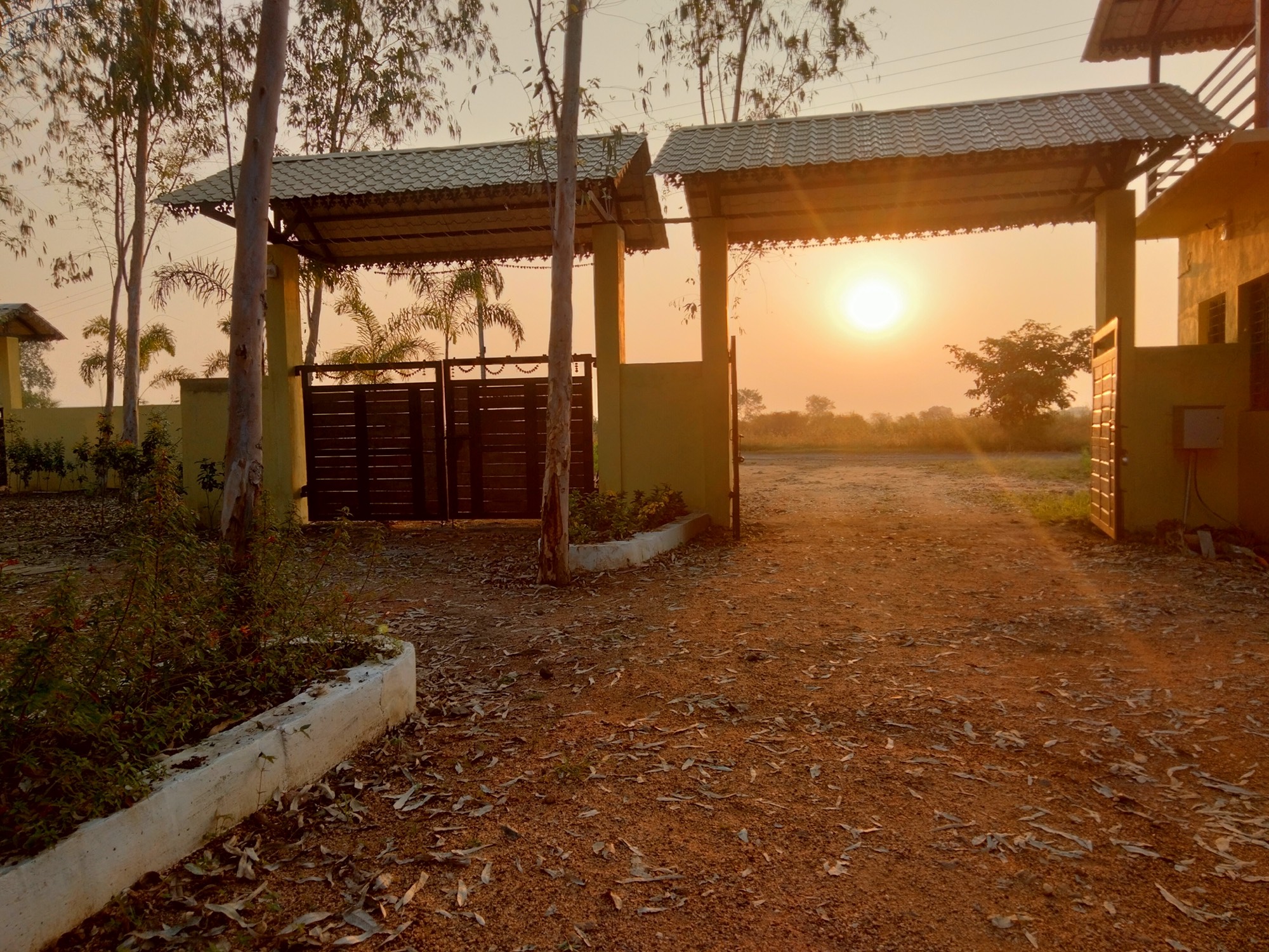 Sunrise through the entrance gate at City Flora Tiger Resort